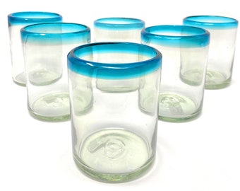 May include: Six clear glass tumblers with a blue rim. The glasses are stacked in a row, with the top glass slightly offset from the others.