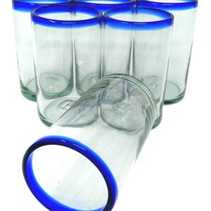May include: Set of six clear glass tumblers with a blue rim. The glasses are stacked and angled, showcasing the blue rim.