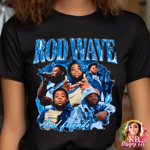 May include: Black t-shirt with a blue and white graphic print of Rod Wave and friends. The graphic features the text "Rod Wave" in a blue and white font and the text "And friends" in a smaller white font.