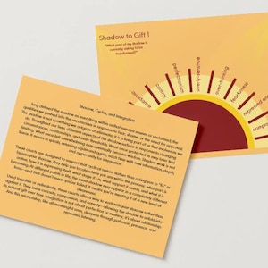 May include: Two orange cards with text and graphics. One card has a semi-circle design with labels like "fearfulness" and "repressed anger." The other card has text about shadow work and integration.