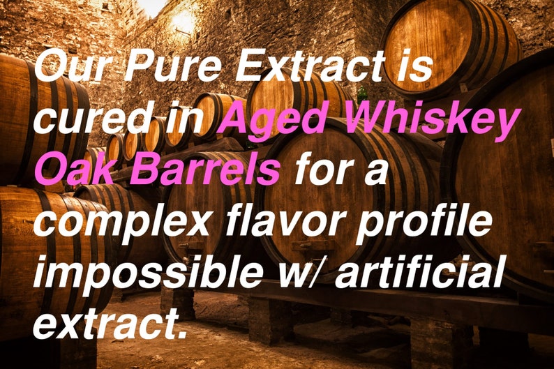May include: A row of wooden barrels stacked in a brick cellar. The text "Our Pure Extract is cured in Aged Whiskey Oak Barrels for a complex flavor profile impossible w/ artificial extract." is superimposed on the image.