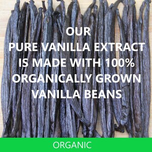 May include: Close-up of a bunch of dark brown vanilla beans on a wooden surface. The text "OUR PURE VANILLA EXTRACT IS MADE WITH 100% ORGANICALLY GROWN VANILLA BEANS" is written in white letters on a black background. The text "ORGANIC" is written in white letters on a green background.