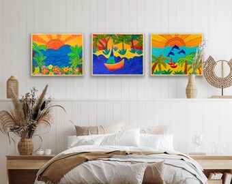 May include: Three framed paintings depicting colorful scenes of tropical islands with palm trees, blue water, and a sailboat. The paintings are hung on a white wall above a bed with a brown blanket and white pillows.