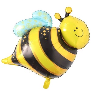 May include: A yellow and black bee-shaped balloon with a blue and white patterned wing. The balloon has a smiling face and is made of foil.
