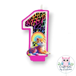 May include: A pink and white birthday candle shaped like the number one. The candle has a rainbow and a cheetah print design. The cheetah is sitting on a rainbow.