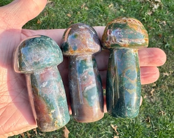 May include: Three polished green, brown, and red jasper mushroom shaped stones.
