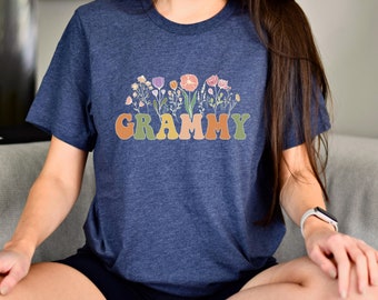May include: A navy blue t-shirt with a floral design and the word "GRAMMY" in colorful letters.