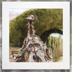 May include: Watercolor painting of a whimsical creature with a long neck, wearing goggles and a long white beard. The creature is sitting in front of a green leafy background.