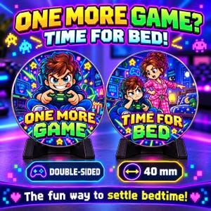 May include: A double-sided circular gaming token measuring 40 mm in diameter. One side features a cartoon character playing a video game with the text ONE MORE GAME. The other side shows a character playing while another stands by with the text TIME FOR BED.