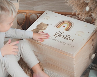 May include: A wooden keepsake box with a light brown stain. The lid features a hand-painted design of a brown bear, a rainbow with a heart in the center, and the name Anton. The date 10.05.2022, 3500 g, and 50 cm are also written on the lid.