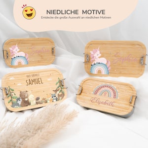 May include: Four wooden lunchboxes with different designs. The lunchboxes are decorated with a unicorn, a rainbow, a forest scene, and a rainbow with a heart. The lunchboxes are labeled with the names Sophia, Sophia, Samuel, and Elisabeth.