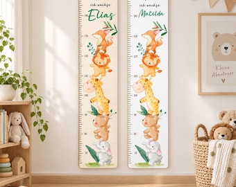 May include: Two vertical wooden growth charts featuring a measurement scale from 70 to 150 cm. Each chart displays the German text 'Hurra ich wachse' with the names 'Elias' or 'Matilda' and illustrations of a fox, lion, giraffe, bear, and elephant.