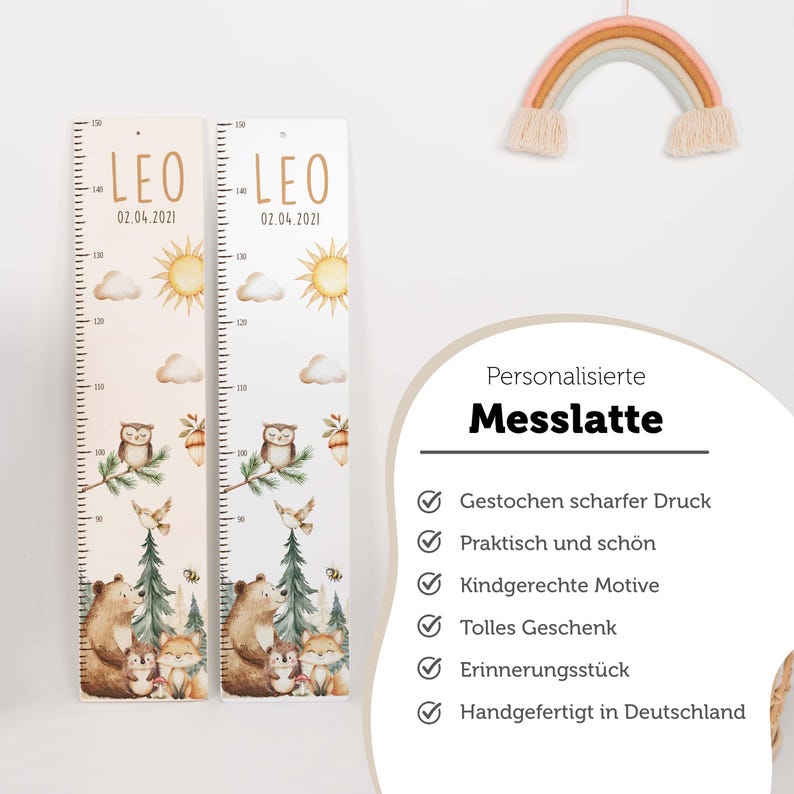 May include: Two vertical wooden growth charts featuring the name LEO and the date 02.04.2021. The designs include illustrations of a sun, clouds, an owl, a bear, a hedgehog, and a fox. A text box lists features in German, including the word Messlatte.