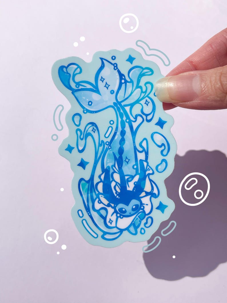 May include: A blue and white sticker featuring a cartoon character with a mermaid tail, surrounded by swirling water and stars. The character is wearing a white dress and has a blue bow on its head.