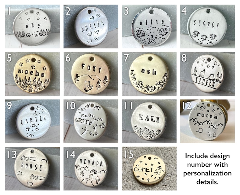 May include: A collection of personalized pet tags with various designs. Each tag is a different shape and features stamped text and illustrations. Designs include names, nature scenes, and celestial motifs. The tags are made of metal.