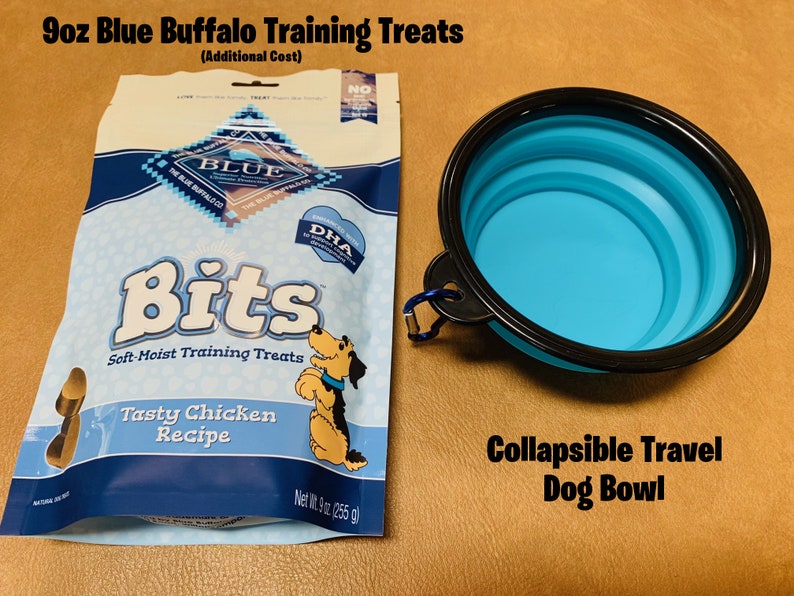 May include: A 9 ounce bag of Blue Buffalo Bits soft-moist training treats for dogs, featuring a tasty chicken recipe. The bag is blue and white with a picture of a dog on it.  Next to the bag is a blue collapsible travel dog bowl.