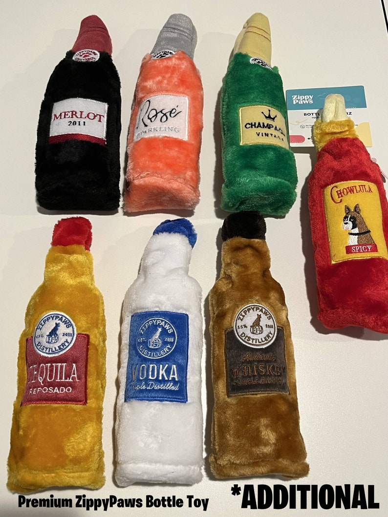 May include: Set of eight plush dog toys shaped like bottles of alcohol. The bottles are labeled with different types of alcohol, including Merlot, Rose, Champagne, Tequila, Vodka, Whiskey, and Hot Sauce. The toys are made by ZippyPaws.