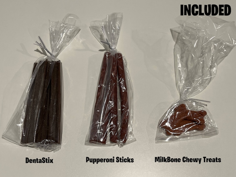 May include: Three bags of dog treats. The first bag contains brown DentaStix, the second bag contains red Pupperoni Sticks, and the third bag contains brown MilkBone Chewy Treats. The text "INCLUDED" is written in black at the top of the image.