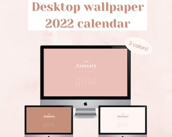 May include: Three computer monitors displaying a 2022 January calendar desktop wallpaper in three different colors: blush pink, brown, and off-white. The text "Desktop wallpaper 2022 calendar" is at the top.