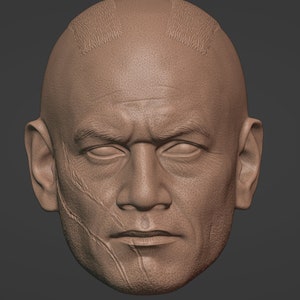 May include: A close-up of a 3D model of a man's face. The model is sculpted in a realistic style and shows detailed features, including wrinkles and scars. The man has a shaved head with a few lines of hair on the top.