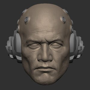 May include: A 3D model of a person's head with a futuristic headset. The headset has a gray, textured surface and is attached to the head with straps. The person's face is detailed with wrinkles and a serious expression.