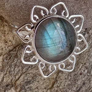 Silver ring in the shape of a flower with labradorite
