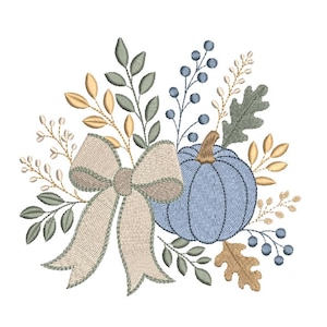 May include: An embroidery design featuring a light blue pumpkin with a brown stem, accented by a large beige bow with a decorative border. The arrangement includes sprigs of green leaves, small blue berries, and tan oak leaves.