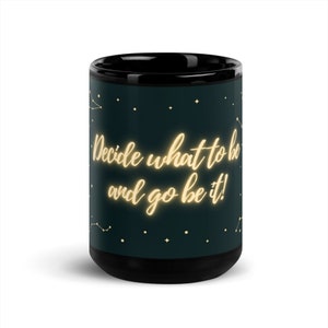 May include: Black coffee mug with a dark green background and gold constellation design. The text "Decide what to be and go be it!" is written in gold.
