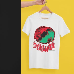 May include: White t-shirt with a red, black, and green graphic of a demon with the text "DEVILMAN" and "DYNAMIC PLANNING" underneath.