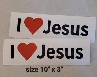 May include: Two white stickers with the text "I love Jesus" in black letters and a red heart. The stickers are 10 inches by 3 inches.