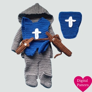 May include: Crochet pattern for a baby knight costume. The costume includes a grey hooded tunic, blue armor with a white cross, brown swords, and a blue shield with a white cross.