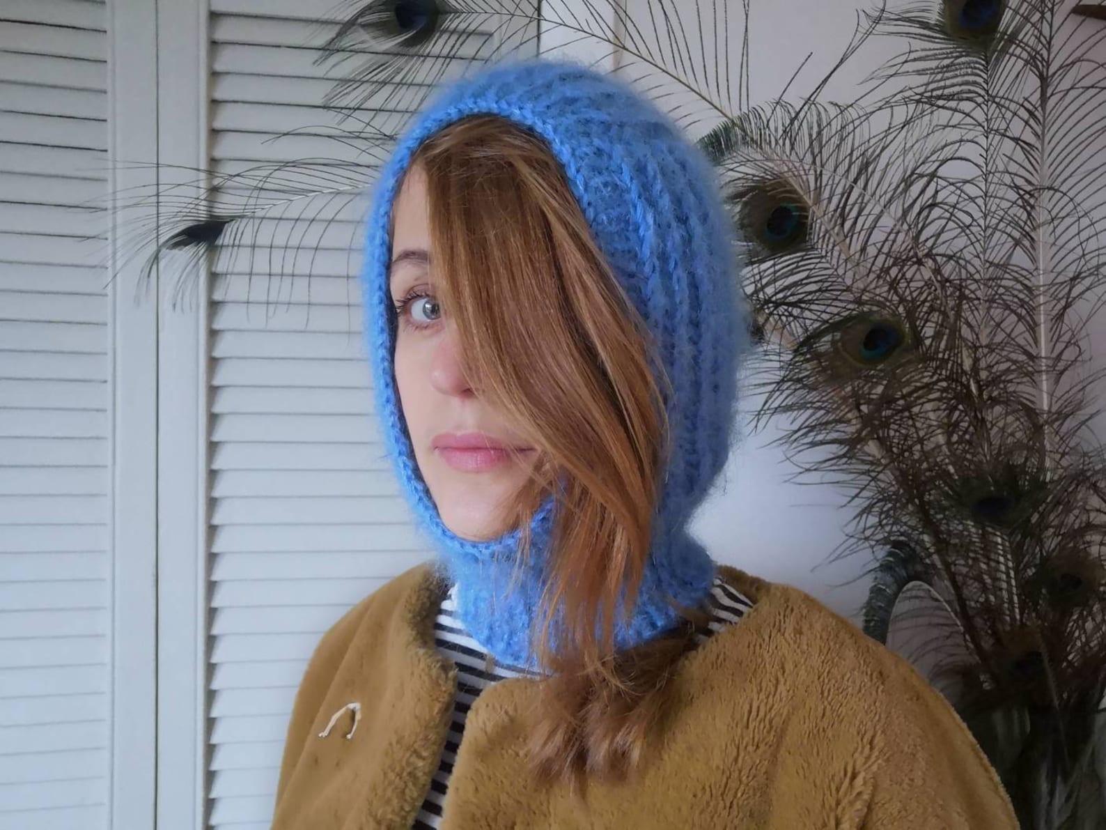 Knitted Hoods and Balaclavas are a winter essential. Hand-knitted mohair and wool blend balaclava / knitted hood. The soft and cosy hood with a fuzzy finish pulls on to keep the head and neck warm with an opening for the face. This version comes in cerulean blue.