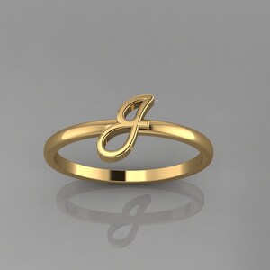 May include: A gold ring with a cursive letter J on the side.