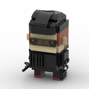 Könnte beinhalten: Eine schwarze Lego-Minifigur einer Person, die eine schwarze Maske, ein schwarzes Hemd und eine schwarze Hose trägt. Die Minifigur hält eine schwarze Pistole in ihrer rechten Hand. Die Minifigur hat ein braunes Gesicht mit einer schwarzen Augenmaske und einem schwarzen Haarstück.