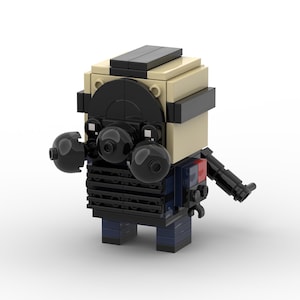 May include: A Lego minifigure of a character wearing a black helmet, black goggles, a black vest, blue pants, and holding a black gun.