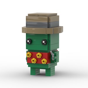 May include: A green and red Lego minifigure wearing a brown hat and holding a gun. The minifigure has yellow flowers on its chest.