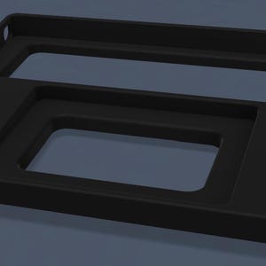 May include: A matte black rectangular tray featuring two distinct recessed sections. The larger upper section is elongated and horizontal, while the smaller lower section is rectangular. The tray has a smooth, solid construction with rounded edges.