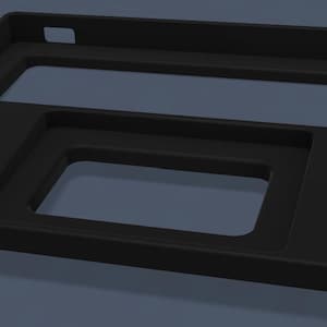 May include: A matte black rectangular tray featuring two distinct recessed cutouts. The larger upper cutout is elongated and rectangular, while the smaller lower cutout is a smaller rectangle. The tray has a raised border and a small square notch.