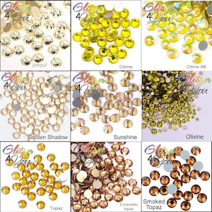 May include: A collection of nine distinct groups of round, faceted rhinestones labeled with the text Glitzer 4 You. The colors include jonquil, citrine, citrine AB, golden shadow, sunshine, olivine, topaz, light colorado topaz, and smoked topaz.