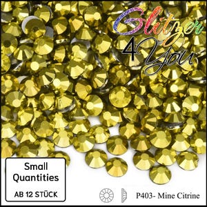 May include: A collection of small, round, golden-yellow rhinestones. The image includes text that reads "Glitzer 4 You", "Small Quantities", and "AB 12 STÜCK". The product is labeled "P403- Mine Citrine".
