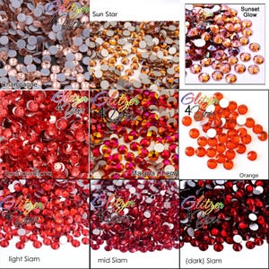 May include: A collection of round, faceted rhinestones in various shades of red, orange, and champagne. The colors are labeled as Champagne, Sun Star, Sunset Glow, Padparadscha, Magma Cherry, Orange, light Siam, mid Siam, and dark Siam.