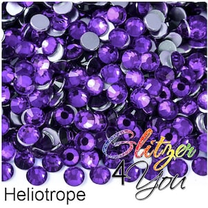 May include: A large quantity of small, round, purple rhinestones. The rhinestones have a faceted, iridescent finish.