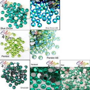 May include: A collection of round, faceted flat-back rhinestones in various shades of green and blue, labeled as Blue Zircon, Blue Zircon AB, Peridot, Peridot AB, Parakeet, Emerald, and Mint, with the Glitzer 4 You logo visible.