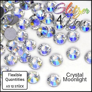 May include: A collection of round, faceted clear crystals with an iridescent finish, displaying blue and yellow light reflections. The image includes the text Glitzer 4 You, Flexible Quantities, AB 12 STÜCK, and Crystal Moonlight.