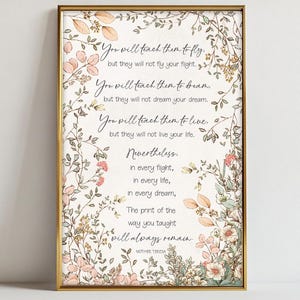 May include: A framed print with a gold border features a quote by Mother Teresa. The text is surrounded by floral illustrations in soft pink, peach, and green hues. The quote reads, "You will teach them to fly..."