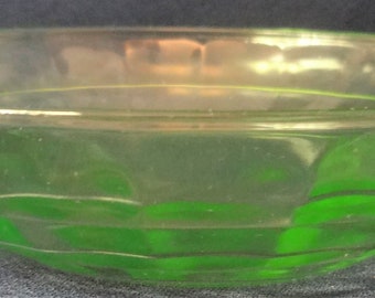 May include: A green glass bowl with a textured, faceted design. The bowl is clear and has a slight green tint.