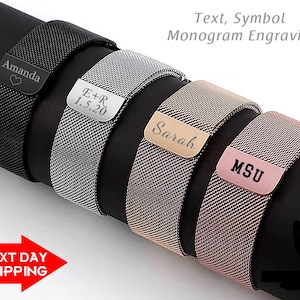 May include: Four different metal watch bands with engraved text. The bands are black, silver, gold, and rose gold. The text on the bands reads "Amanda", "E+R 1.5.20", "Sarah", and "MSU".