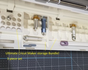 May include: A white Cricut Maker storage bundle with various tools and accessories. The image shows a 3-piece set, including blades and other crafting essentials. Text on the image reads "Ultimate Cricut Maker storage Bundle!" and "3 piece set".