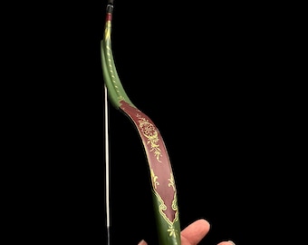May include: A traditional-style bow with a green and red painted finish. The bow has gold accents and intricate floral designs.