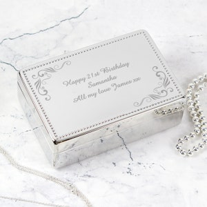 May include: Silver jewellery box with an engraved message: "Happy 21st Birthday Samantha All my love James xx".